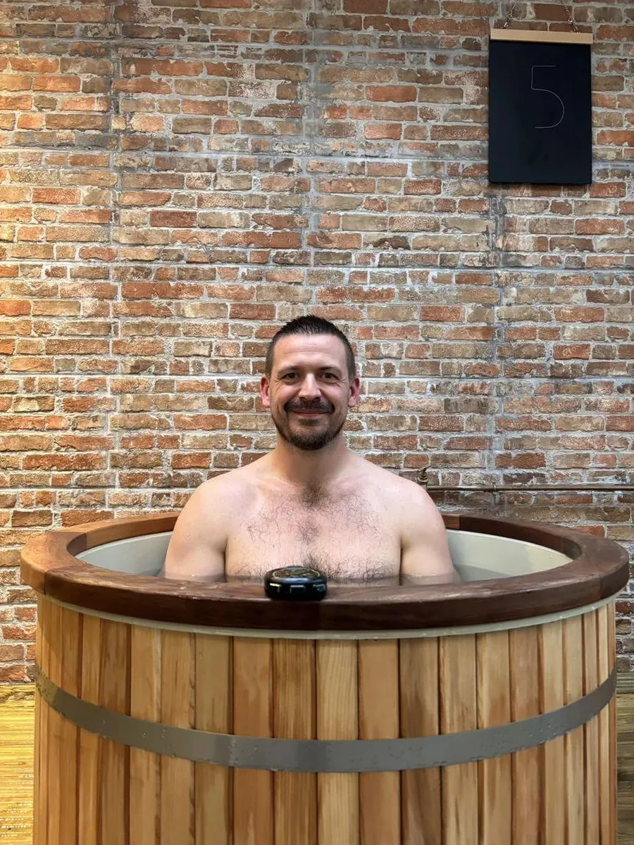 A member taking a quiet moment in a cold plunge