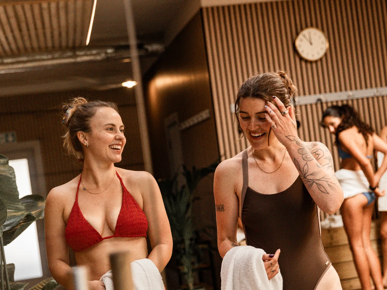 Two members laughing with towels at Pulse Club Putney
